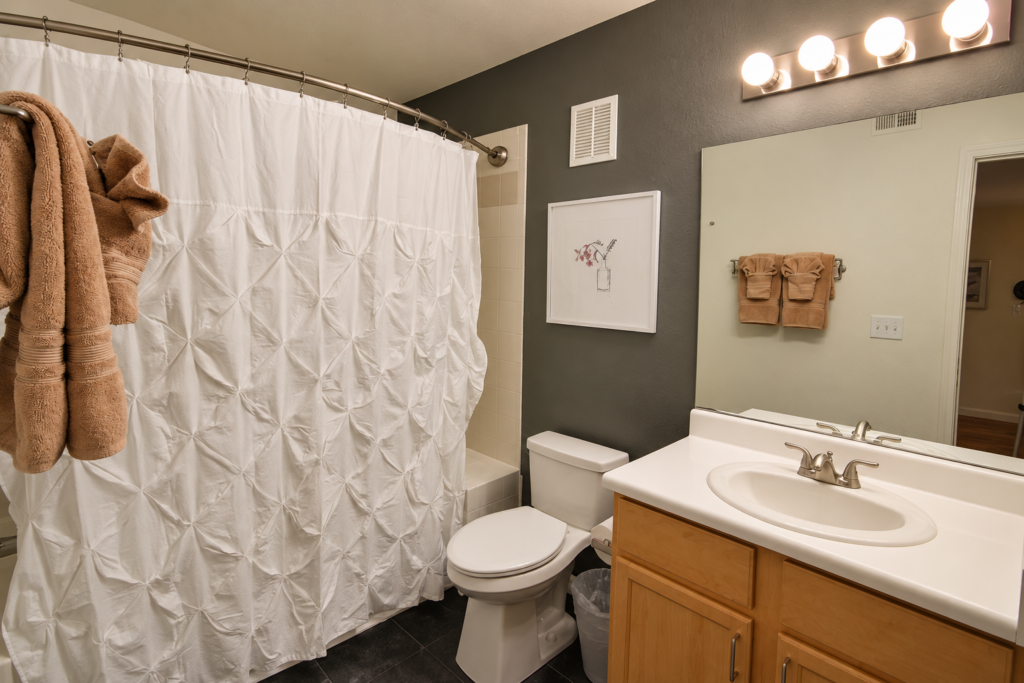 Modern Charcoal Bathroom with Warm Vanity Lighting- Spectrum 140 Henderson NV