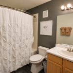 Modern Charcoal Bathroom with Warm Vanity Lighting- Spectrum 140 Henderson NV