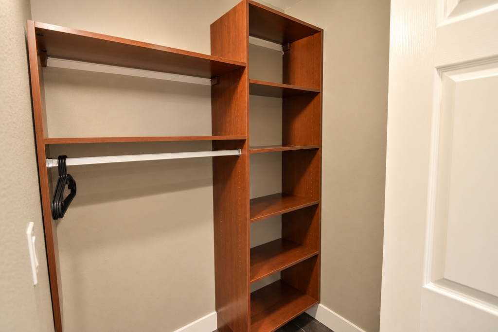 Empty Warm Wood Walk-In Closet